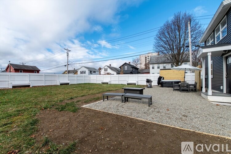 A backyard with a gravel area and a picnic table.