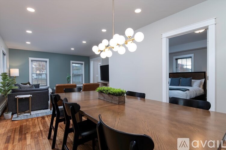 A modern dining room with a wooden table and chairs.