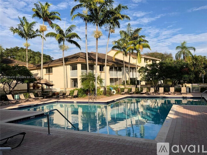 A large house with a pool in front of it.