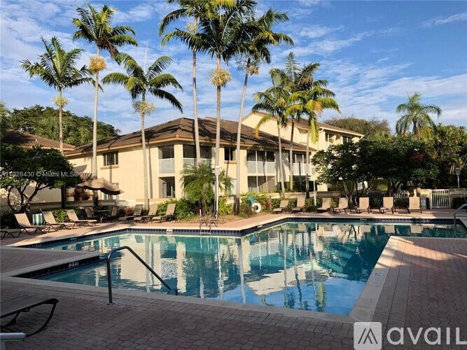 A large house with a pool in front of it.