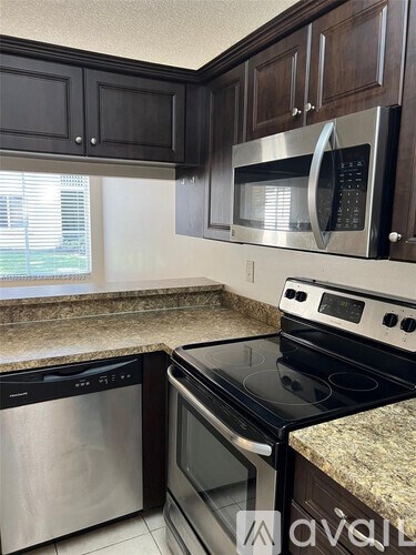 A kitchen with a stove top oven and a microwave above it.