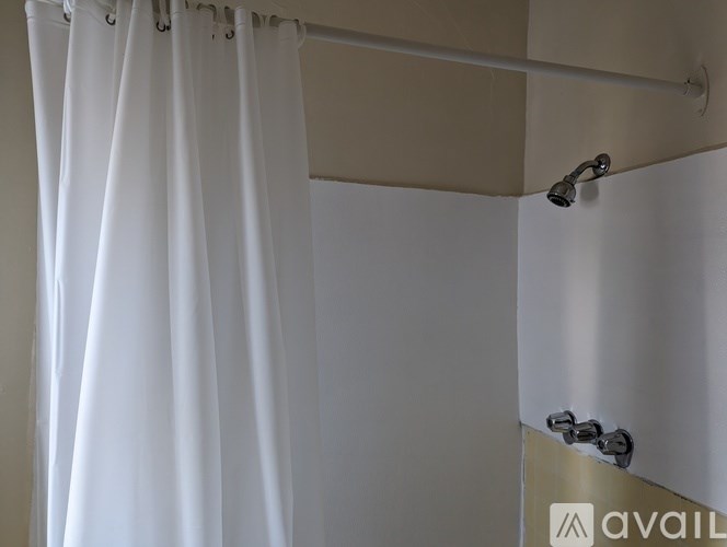 A shower curtain is hanging in a bathroom.