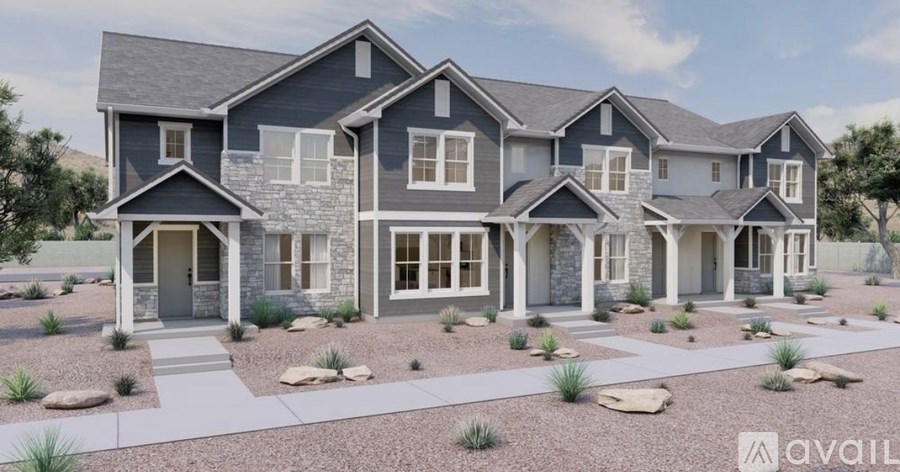A modern house with a grey front yard and a sign that says "available".