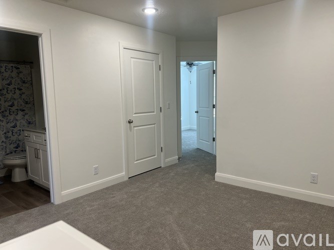 A room with a door, a toilet, and a sink.