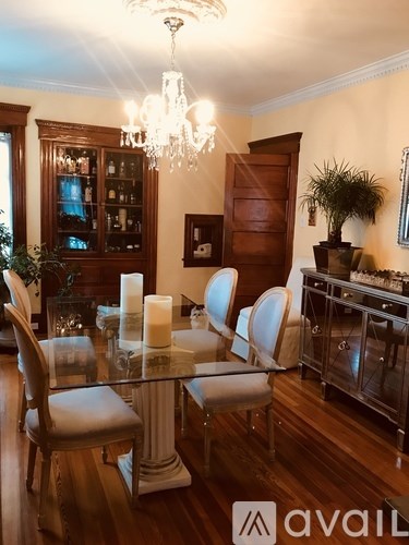 A dining room with a glass table and chairs.
