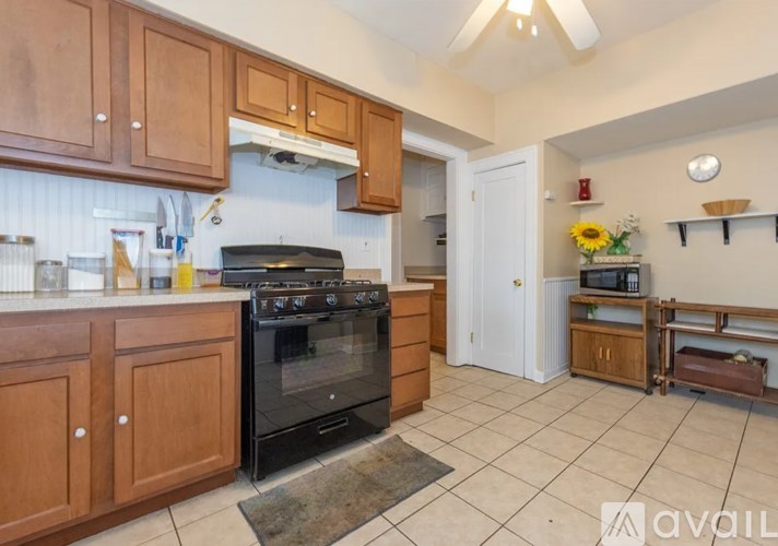 A kitchen with wooden cabinets and a black stove top oven.