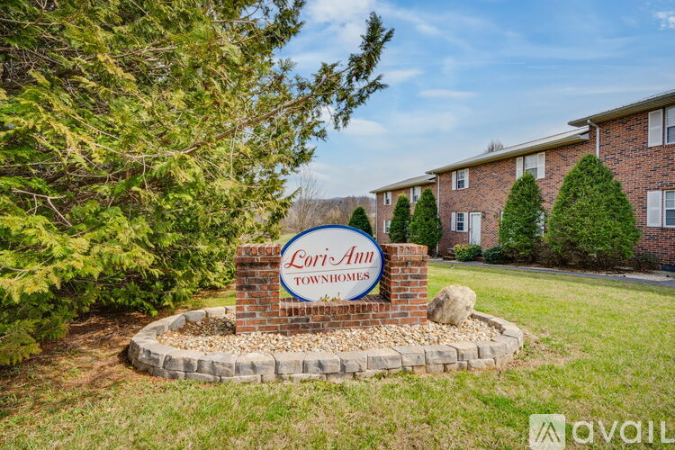 A sign for Lori-Ann Townhomes is displayed in front of a building.