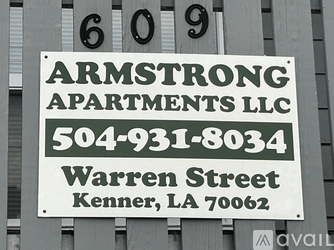 A sign for Armstrong Apartments LLC is displayed on a building.
