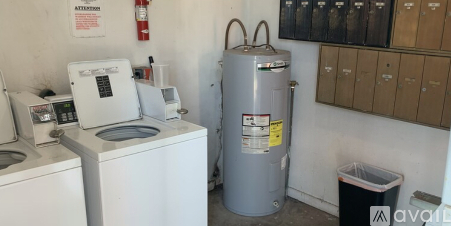 A washing machine and a water heater in a small room.