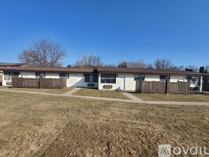 A row of houses with a clear blue sky above.