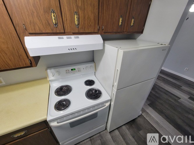 A white stove and dishwasher in a kitchen.