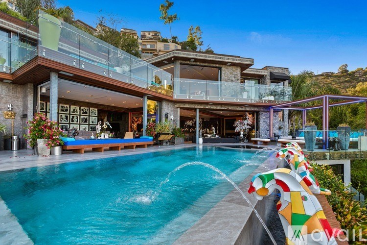 A modern house with a pool in the backyard.