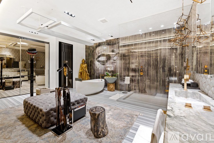 A modern bathroom with a large mirror and a sink.