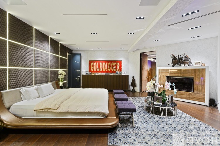 A bedroom with a bed, a fireplace, and a coffee table.