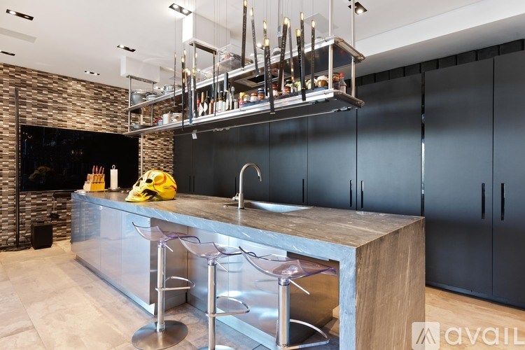 A modern kitchen with a wooden island and stainless steel appliances.