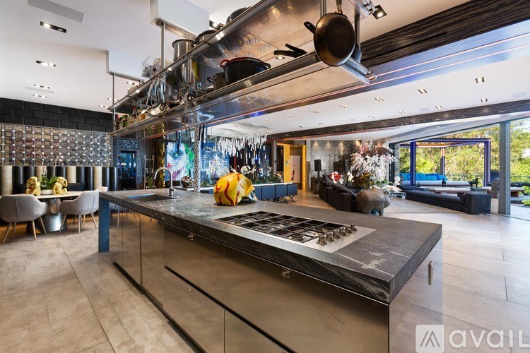 A modern kitchen with a large island and stainless steel appliances.