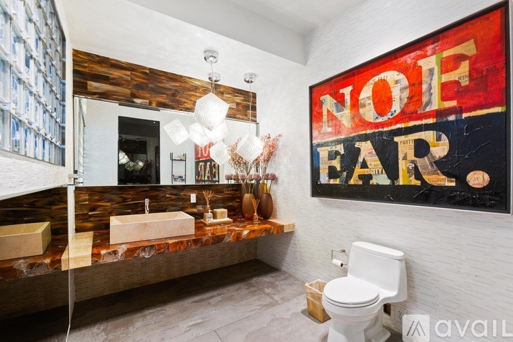 A bathroom with a wooden wall and a toilet.