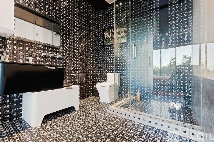 A bathroom with a shower and a toilet.