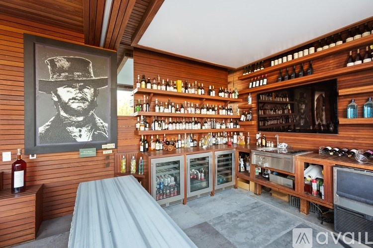 A bar with a wooden wall and a picture of a man in a hat.