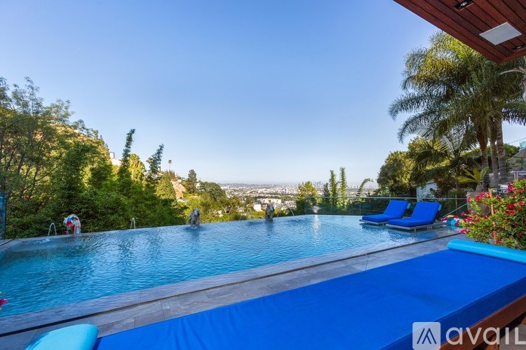 A swimming pool with a view of the city in the distance.