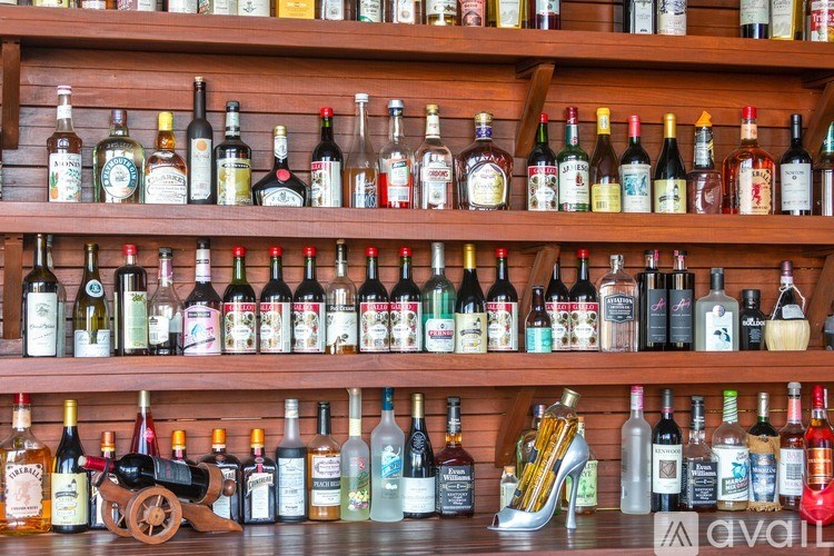 A shelf filled with various bottles of alcohol.