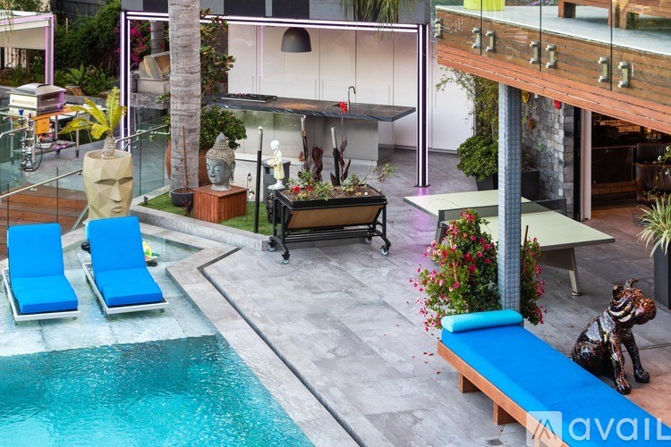 A pool with a blue lounge chair and a bench with a statue of a zebra.