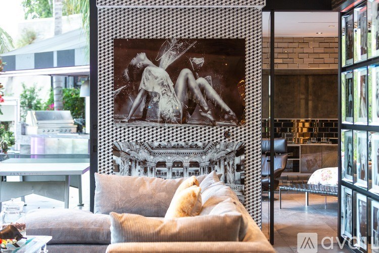 A living room with a couch and a large framed picture on the wall.