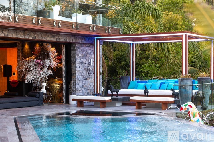 A pool area with a glass wall and a bench.