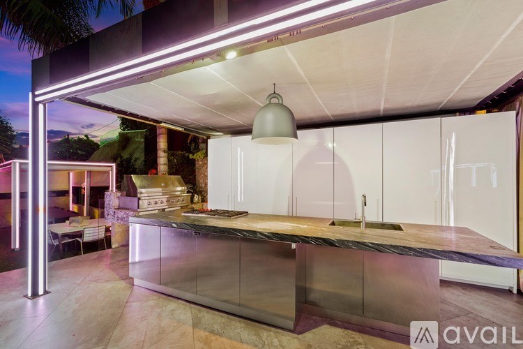 A modern kitchen with a glass countertop and stainless steel appliances.