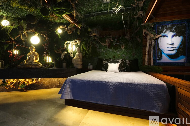 A bedroom with a bed and a mossy wall.