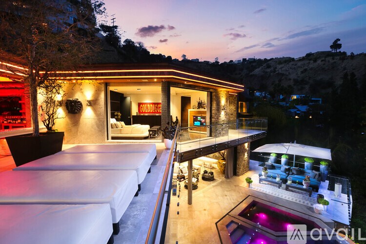 A modern house with a pool and a hot tub.