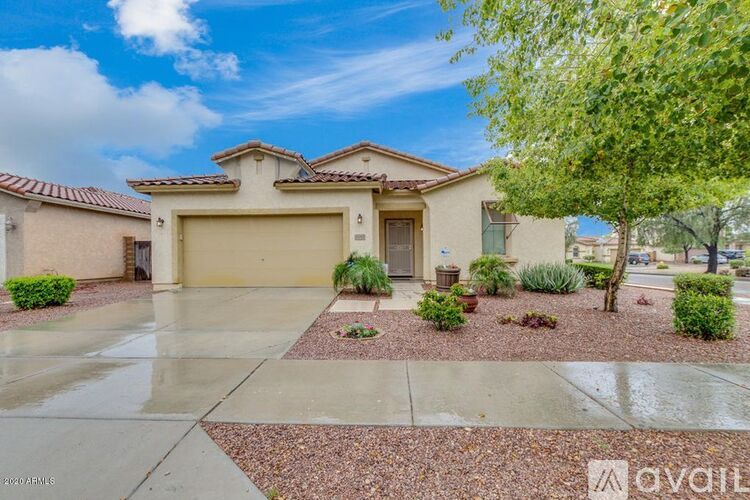 A house with a garage and a driveway in front of it.