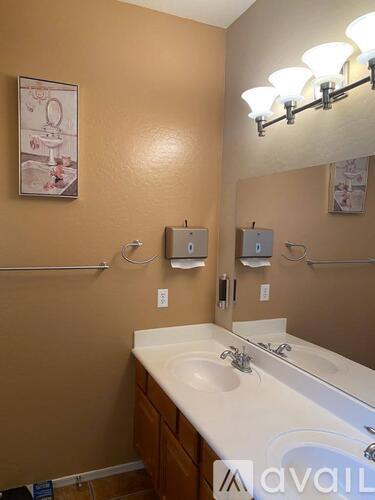 A bathroom with a brown wall and a white sink.
