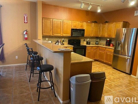 A kitchen with wooden cabinets and a black stove top oven.