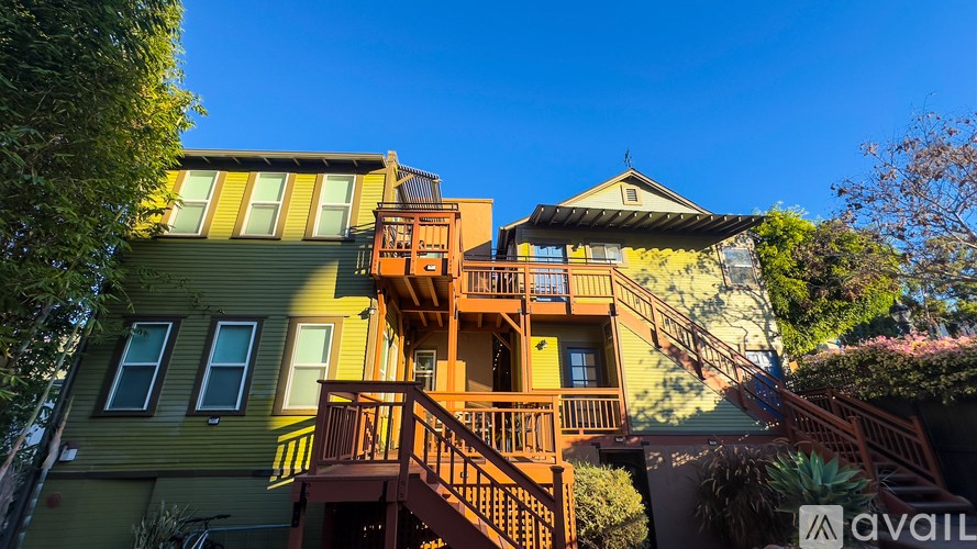 A multi-story building with a balcony and a staircase.