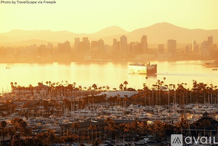 A city skyline is reflected in the water at sunset.
