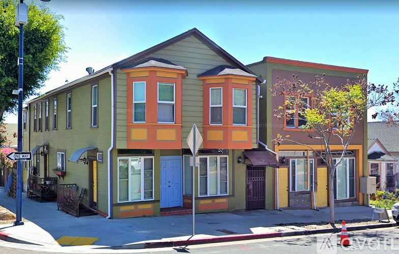 A street view of a row of colorful houses.