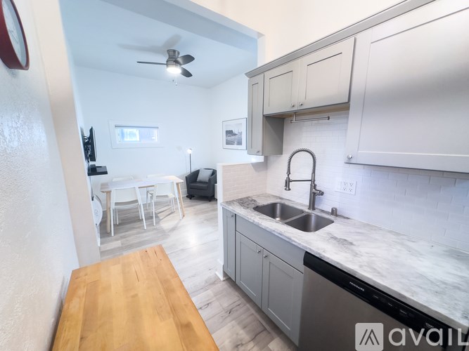 A kitchen with a wooden table and a sink.