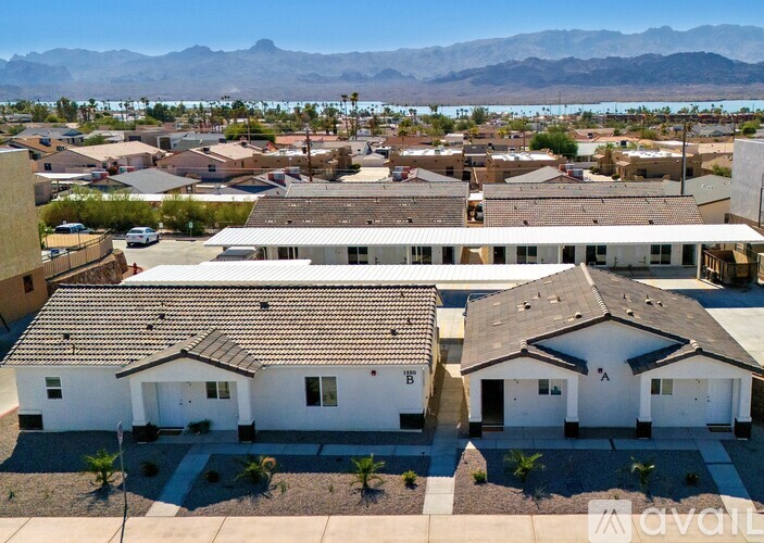 A bird's eye view of a neighborhood with houses and a mountain in the background.