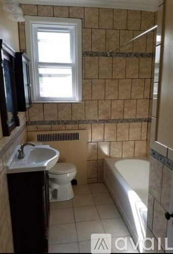 A bathroom with a toilet, sink, and bathtub.