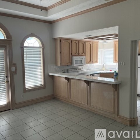 A kitchen with wooden cabinets and a white countertop.