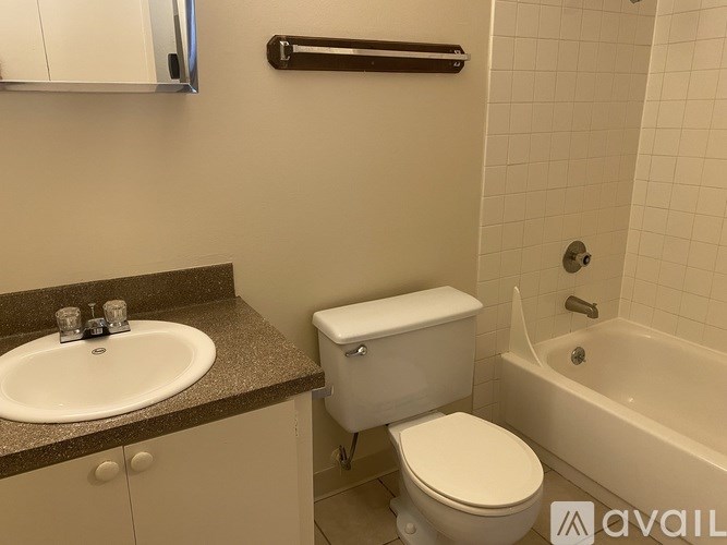 A bathroom with a toilet, sink, and bathtub.