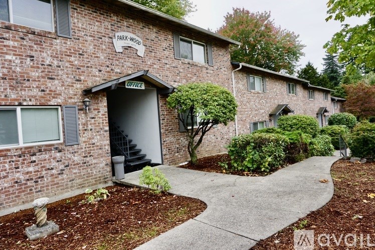 A brick building with a sign that says "PARK HOME OFFICE" on it.
