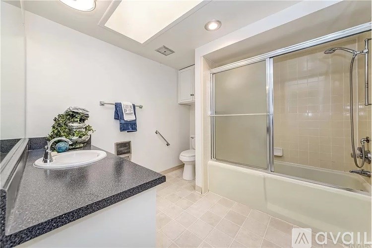 A bathroom with a sink, toilet, and shower.