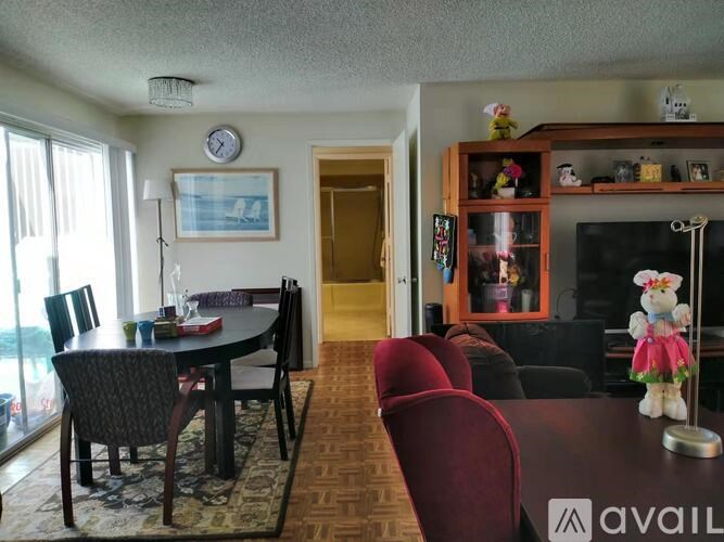 A living room with a dining table and chairs.