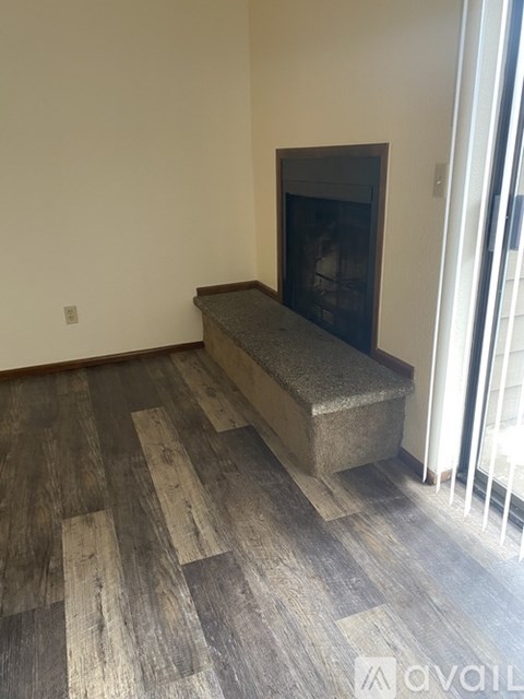 A living room with a fireplace and a television.
