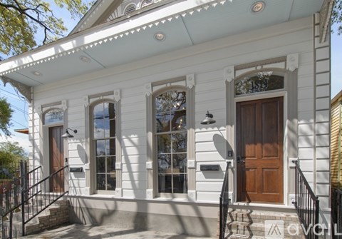 A white house with a brown door and windows.
