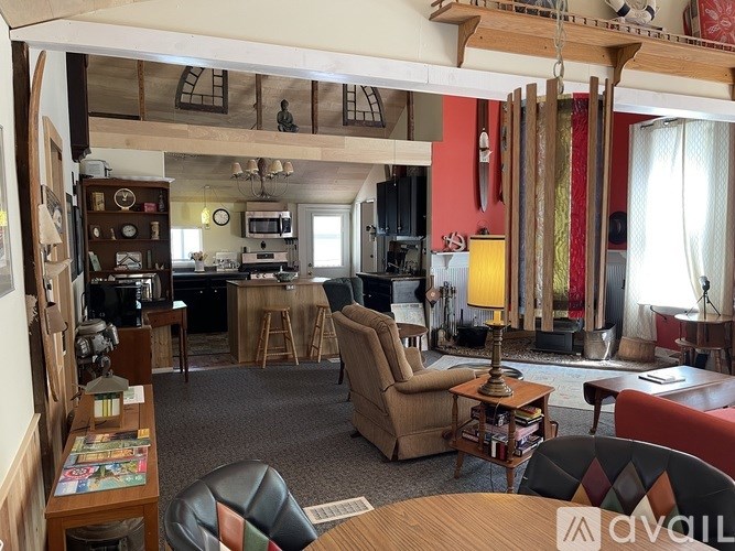 A living room with a couch, chair, and a table.