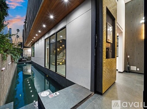 A modern house with a pool in the backyard.
