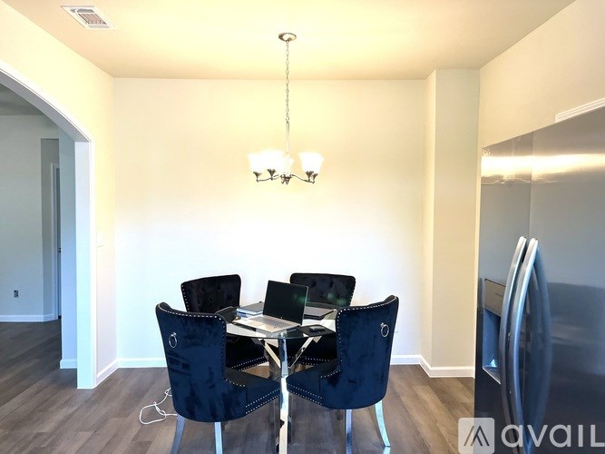 A dining room with a table and chairs.